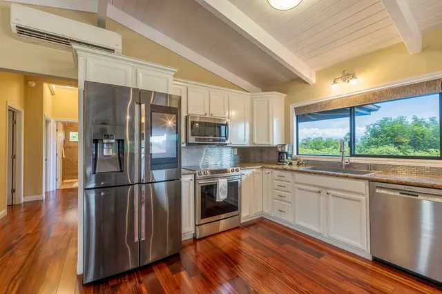 a kitchen with stainless steel appliances a refrigerator sink and microwave