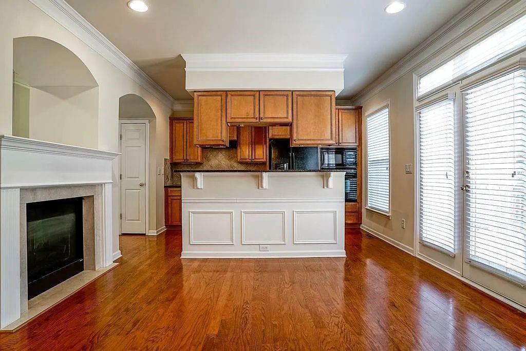6120 Joybrook Road Duluth, GA 30097 - Photo 11 of 30 a view of kitchen with kitchen island wooden floor and fireplace