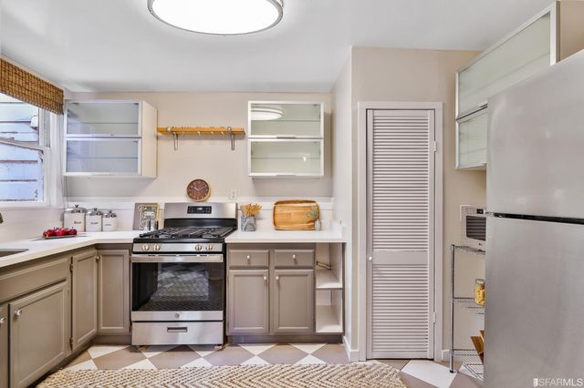 a kitchen with a stove and a refrigerator
