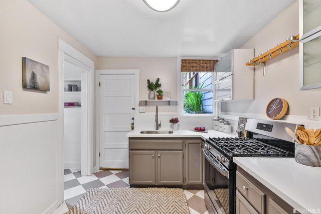 a kitchen with a sink stove and refrigerator
