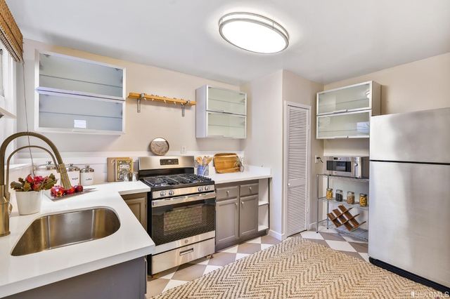 a kitchen with a refrigerator and a sink