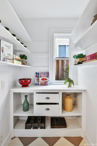 a kitchen with a stove a sink and cabinets