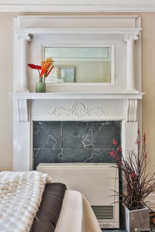 a living room with a fireplace and a potted plant
