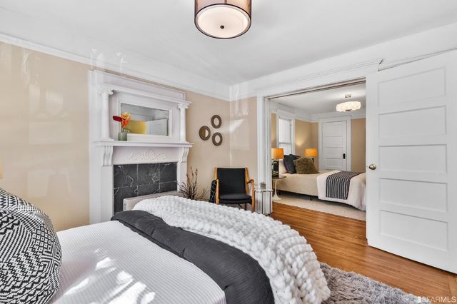 a bedroom with a large bed and a chandelier