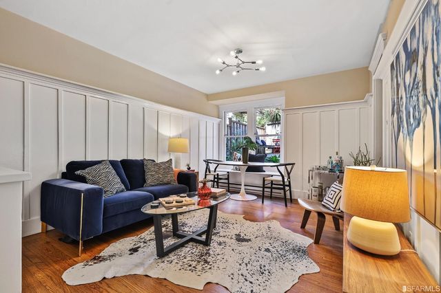 a living room with furniture and a chandelier