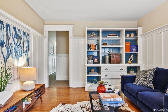 a living room with furniture and a book shelf