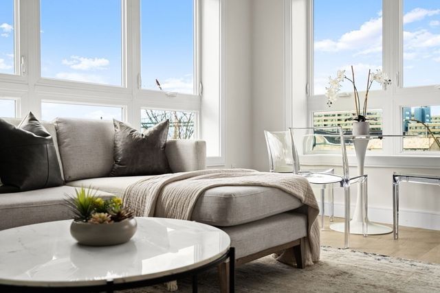 a living room with furniture flowerpot and window