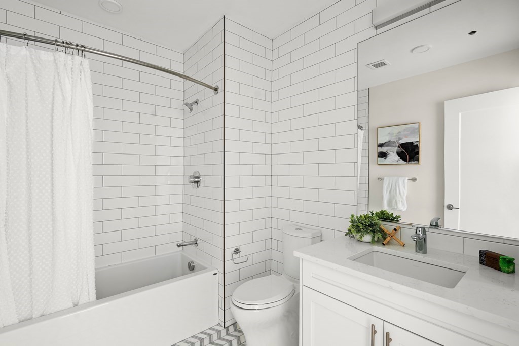 301 Border Street, Unit 311 Boston, MA 02128 - Photo 14 of 33 a bathroom with a shower a sink a toilet and a mirror