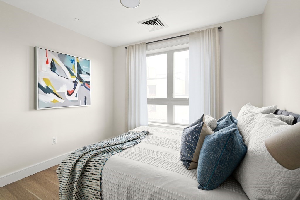 301 Border Street, Unit 311 Boston, MA 02128 - Photo 15 of 33 a bedroom with a bed and a painting on the wall