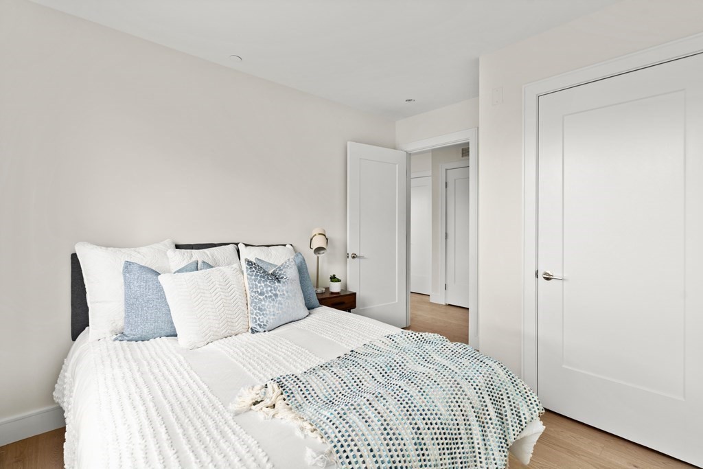 301 Border Street, Unit 311 Boston, MA 02128 - Photo 19 of 33 a bedroom with a bed and wooden floor