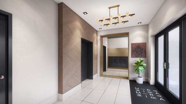 a view of a hallway with wooden floor and a dining room