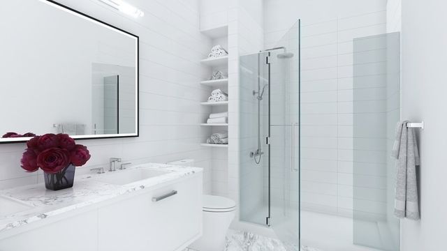a bathroom with a sink vanity mirror and toilet