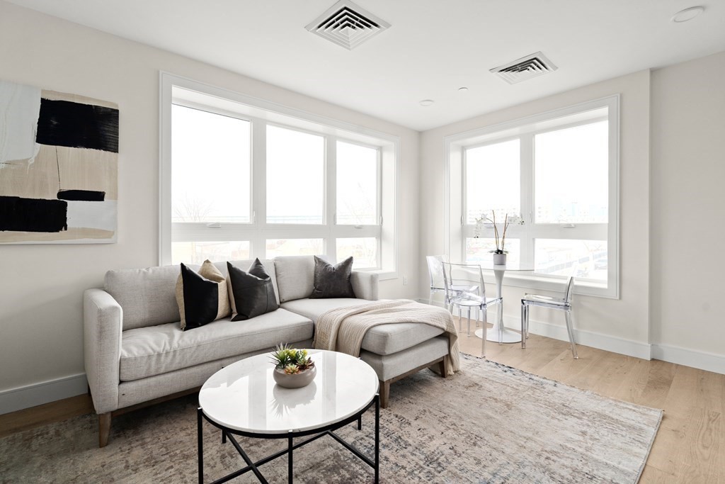 301 Border Street, Unit 311 Boston, MA 02128 - Photo 7 of 33 a living room with furniture and a large window