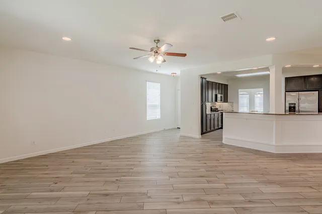 a view of a kitchen with a sink and a kitchen island