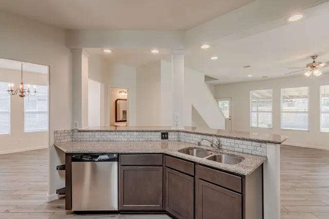 a kitchen with stainless steel appliances granite countertop a sink and a granite counter tops
