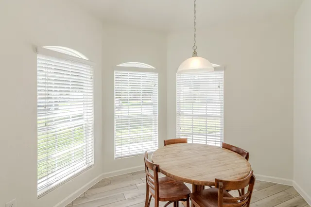 a dining room with furniture and window