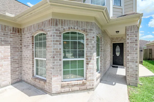 a front view of a house with large windows