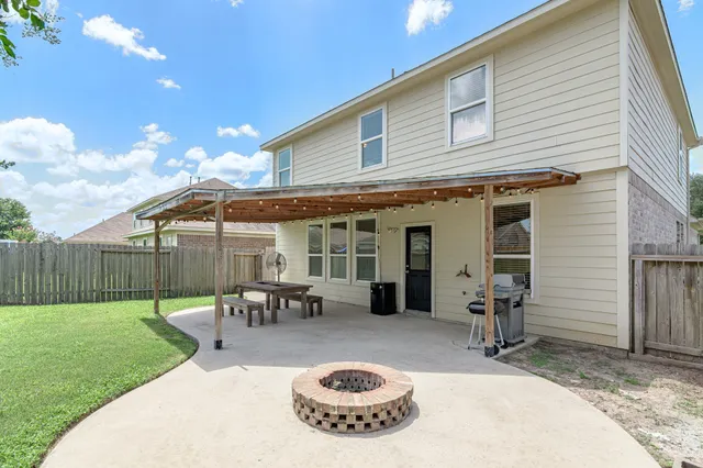 a view of a house with backyard porch and furniture