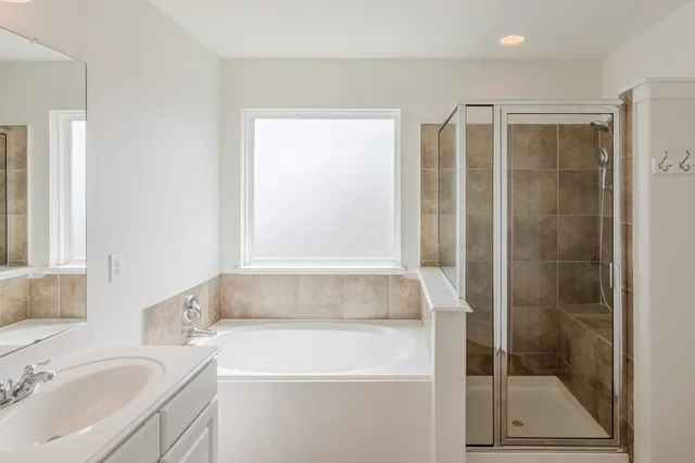 a bathroom with a bathtub and a sink