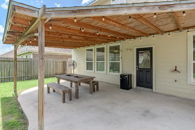 a view of a patio with table and chairs