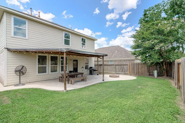 a house view with a sitting space and garden