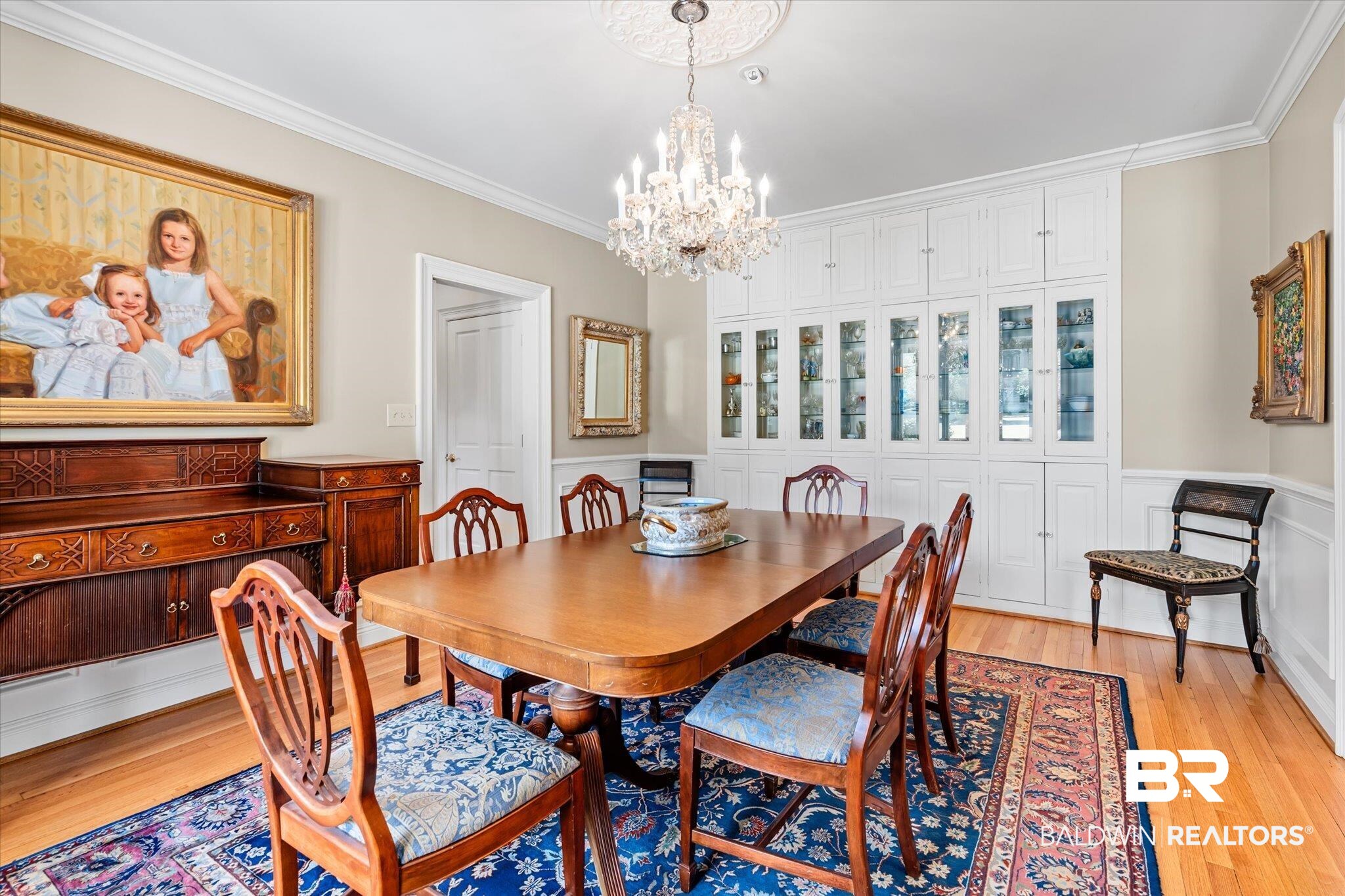 4 Kingsway Mobile, AL 36608 - Photo 6 of 44 Dining space featuring a chandelier, a wainscoted wall, light wood-style flooring, and ornamental molding