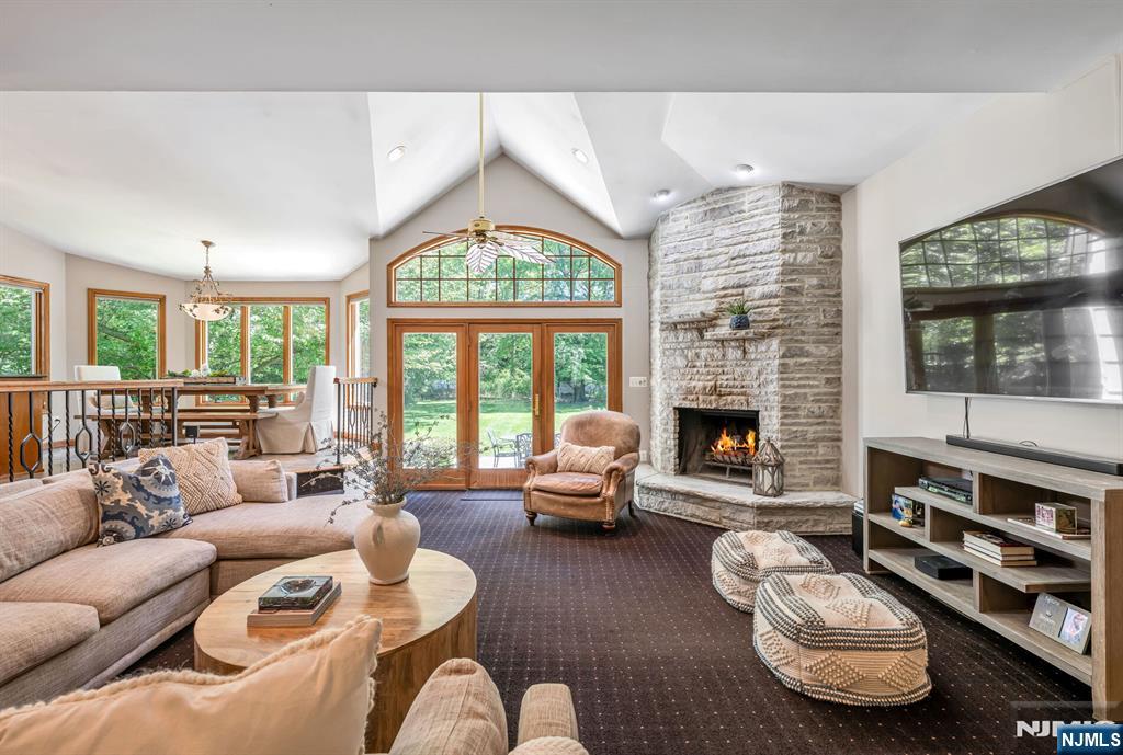 411 Snyder Road Wyckoff, NJ 07481 - Photo 13 of 36 a living room with furniture fireplace and a large window