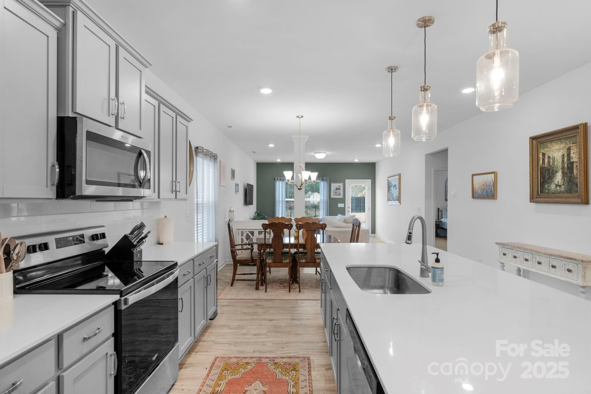 106 Aspire Circle Wingate, NC 28174 - Photo 11 of 39 a large white kitchen with lots of counter space a sink appliances and cabinets