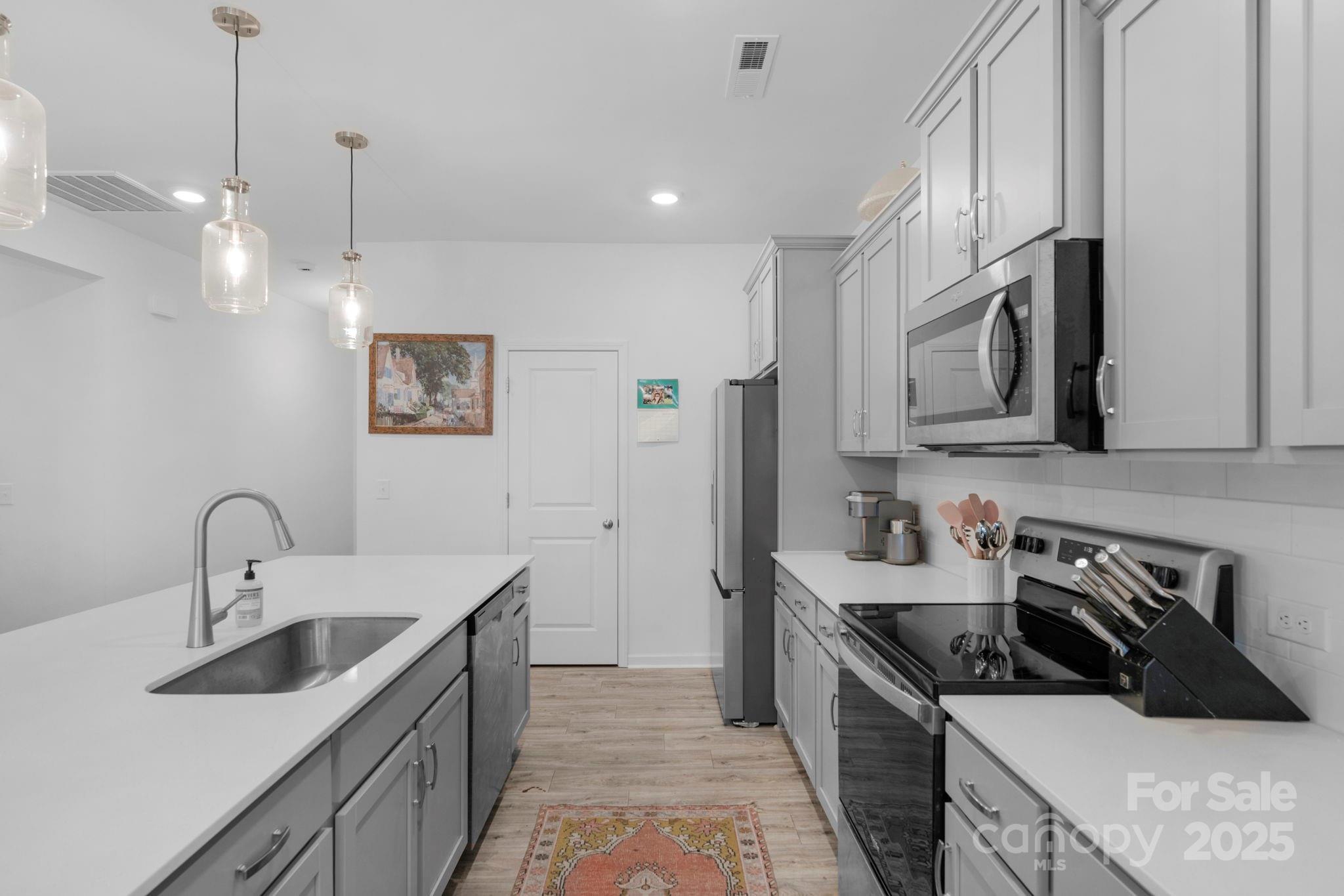 106 Aspire Circle Wingate, NC 28174 - Photo 12 of 39 a kitchen with stainless steel appliances a sink stove and refrigerator