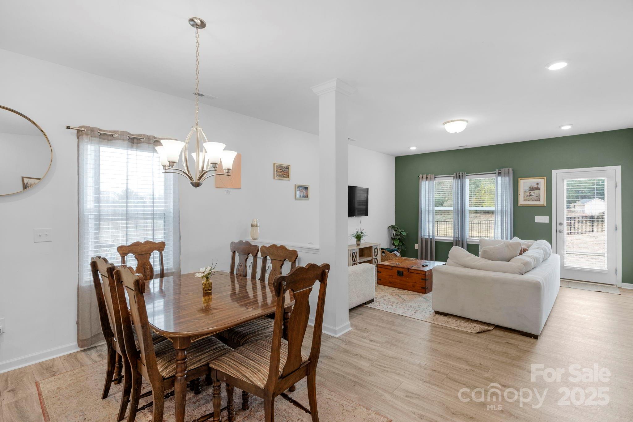 106 Aspire Circle Wingate, NC 28174 - Photo 15 of 39 a view of a dining room with furniture wooden floor and chandelier
