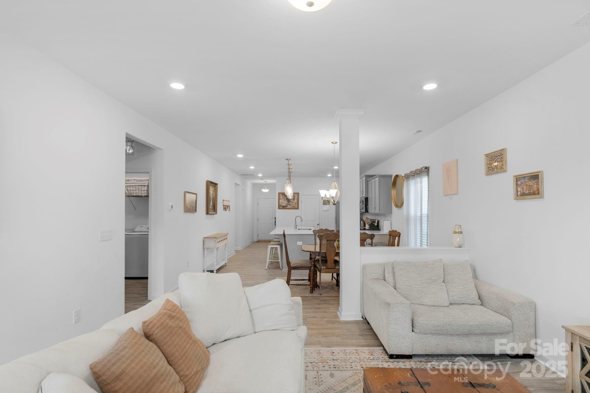 106 Aspire Circle Wingate, NC 28174 - Photo 23 of 39 a living room with furniture and kitchen view
