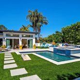 a view of a house with a yard patio and swimming pool