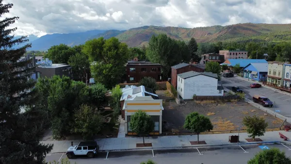 an aerial view of a house with garden space and street view