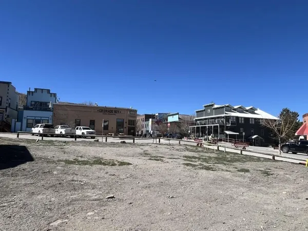 a view of a dirt road and a building