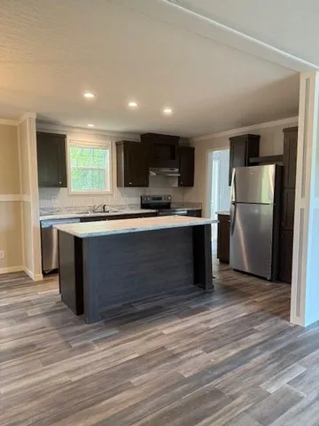 a kitchen with wooden floors and cabinets