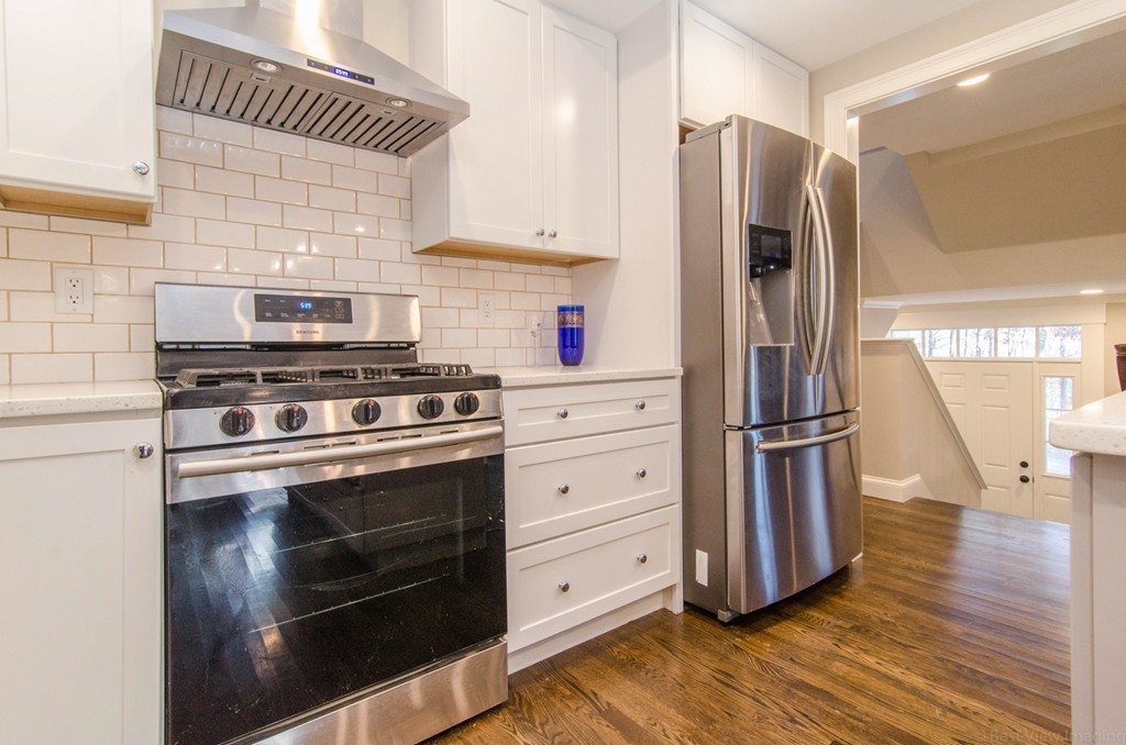 718 Main Street Acton, MA 01720 - Photo 14 of 28 a kitchen with stainless steel appliances a refrigerator stove and wooden floor