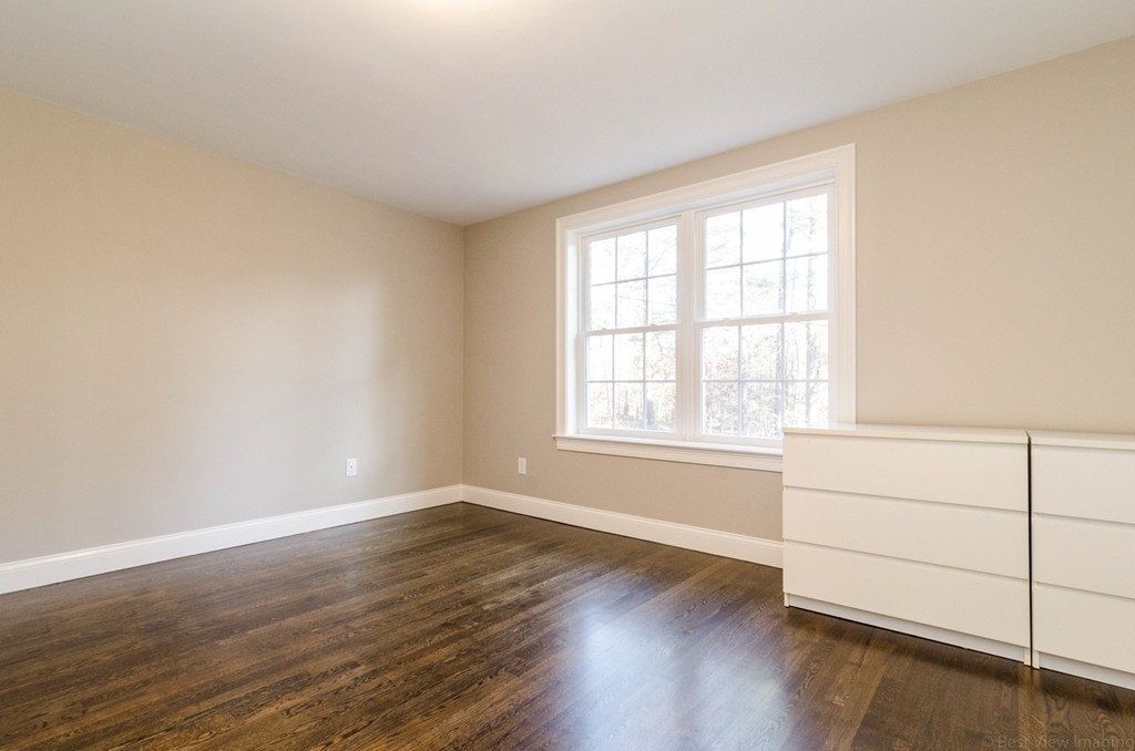 718 Main Street Acton, MA 01720 - Photo 18 of 28 an empty room with wooden floor and windows