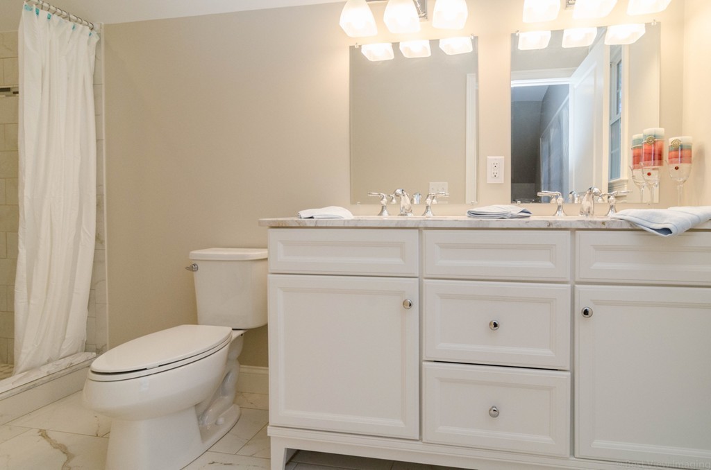 718 Main Street Acton, MA 01720 - Photo 22 of 28 a bathroom with a toilet a sink a vanity and mirror