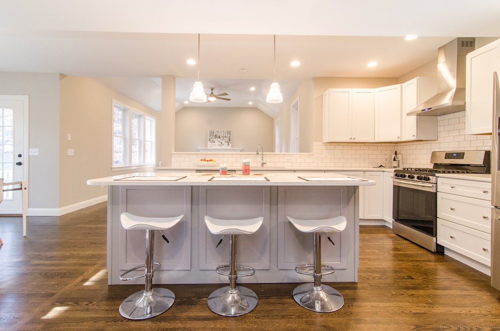718 Main Street Acton, MA 01720 - Photo 10 of 28 a kitchen with stainless steel appliances granite countertop a stove and white cabinets with wooden floor