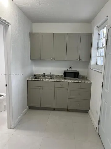 a kitchen with a cabinets and white stove top oven