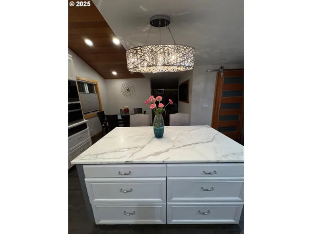 a kitchen with a sink dining table and chairs