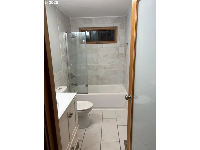 a bathroom with a shower and toilet