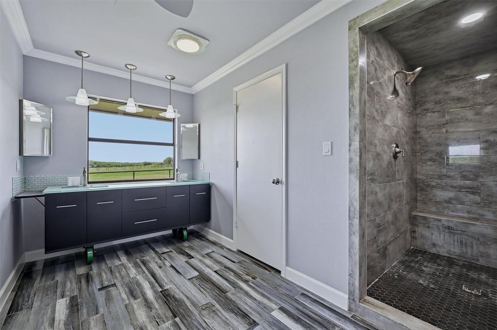 1861-1 Roland Road Whitesboro, TX 76273 - Photo 14 of 39 This bathroom has a large vanity and a stand-alone shower.