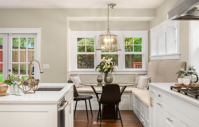 a kitchen with a stove a table and chairs
