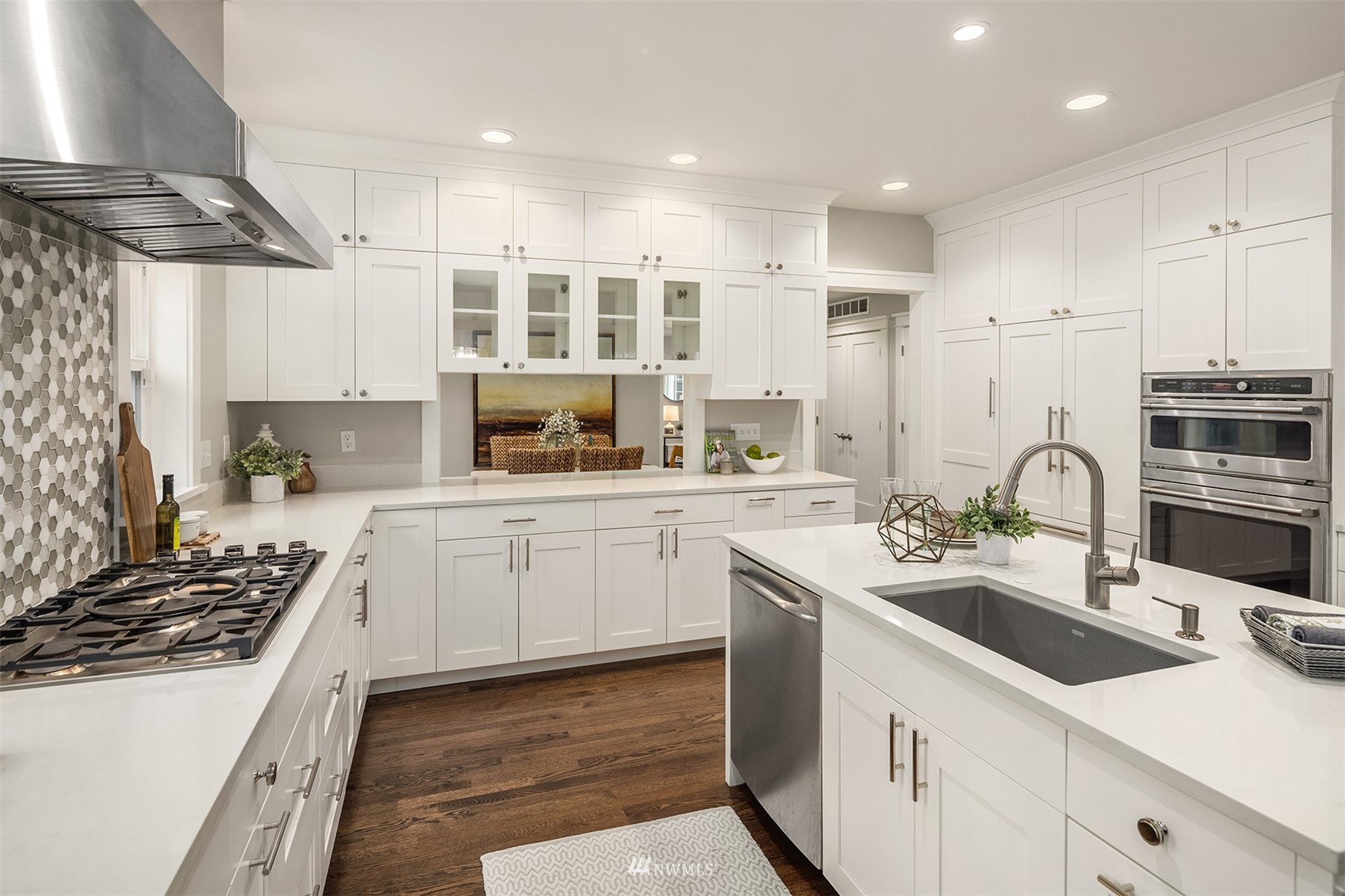 6065 5th Avenue Northeast Seattle, WA 98115 - Photo 16 of 40 a kitchen with white cabinets and appliances