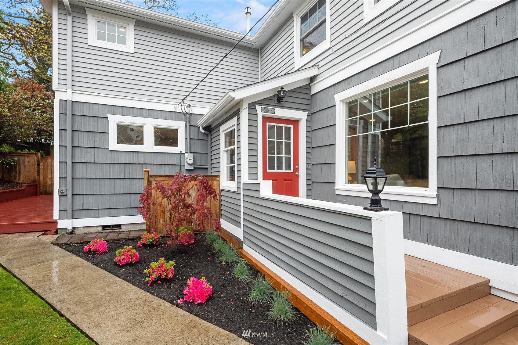 6065 5th Avenue Northeast Seattle, WA 98115 - Photo 2 of 40 a front view of a house with a yard