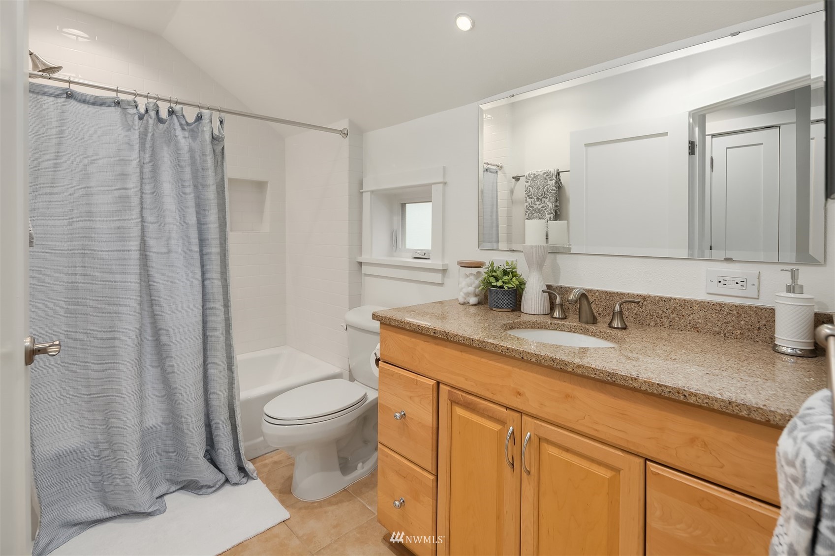 6065 5th Avenue Northeast Seattle, WA 98115 - Photo 23 of 40 a bathroom with a granite countertop sink a toilet and a shower