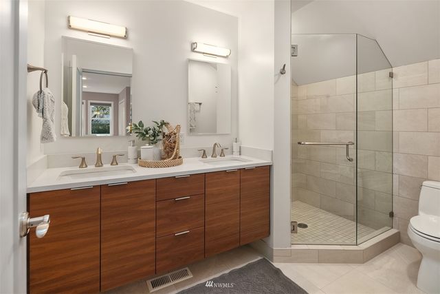 a bathroom with a shower sink and mirror