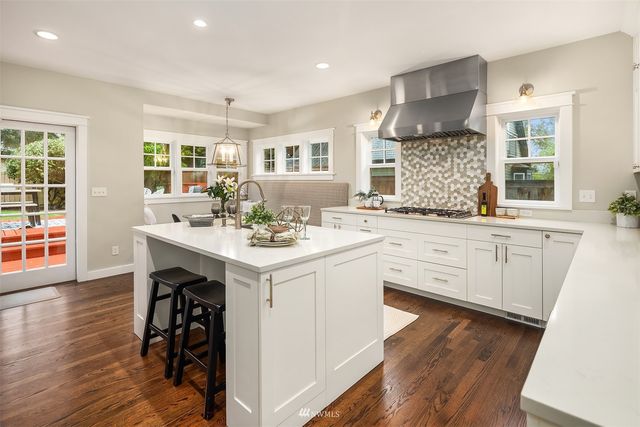 a kitchen with a sink cabinets and wooden floor