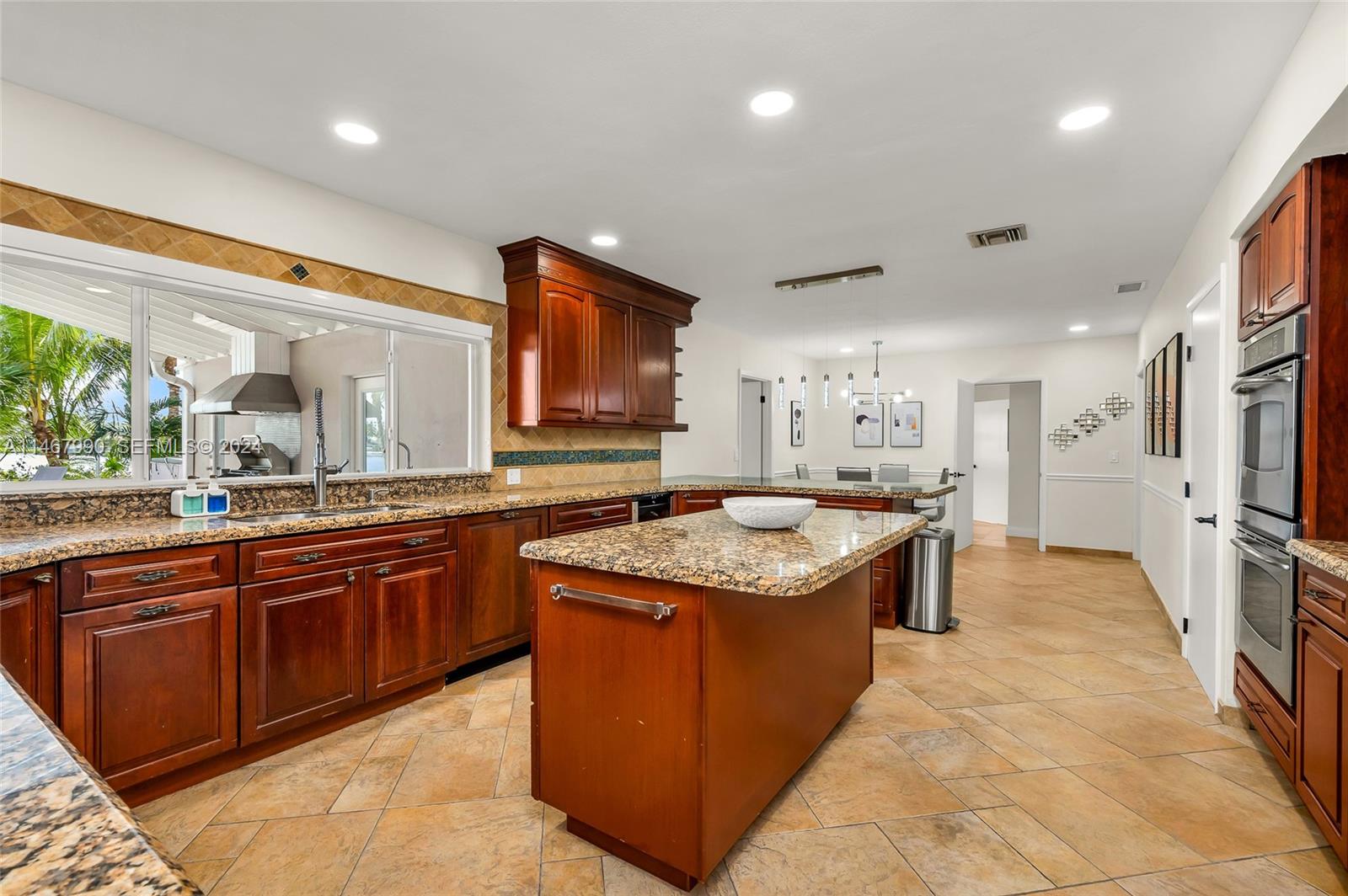2500 Northeast 199th Street Miami, FL 33180 - Photo 13 of 72 a large kitchen with a stove and a sink
